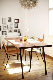 Design Publishing Editor in Berlin, Germany<br><br>"Quite a few of our things come from places like Bolia, BoConcept and Hay, combined with flea market finds and DIY pieces. I built that table together with my dad. I had been looking for a table that would function both as a desk and a dining table for quite some time, but what I found wasn't either quite right or just too expensive. So I asked my dad, who's very handy, if he'd come to Berlin for a weekend and help me build my own table. It's exactly how I wanted it. The chairs came from a vintage store around the corner. I don't know if it's true, but the owner told me they were once used in a church in Denmark, and I varnished them to match the table top."