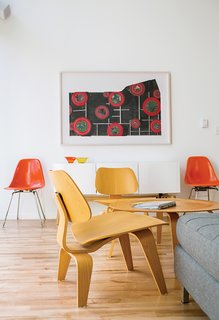 A Versatile House Fulfills All This Musician's Needs - Photo 6 of 11 - Magill furnished the living area with an Eames coffee table and molded plywood chairs that she bought from a neighbor. The Eames fiberglass chairs were eBay purchases, and the Alba credenza is from CB2. The lithograph is by St. Louis artist Sage Dawson.