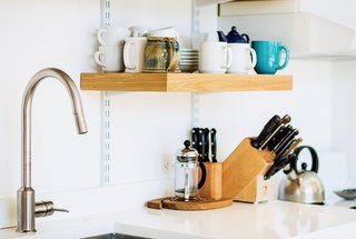 A Versatile House Fulfills All This Musician's Needs - Photo 8 of 11 - C & G Construction made the kitchen shelving from reclaimed cypress not used in the siding and decking. The White Cliff countertops are from Cambria, and the faucet is from Ikea.