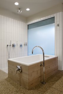 The master bath features a freestanding bathtub and elegantly curved spout.