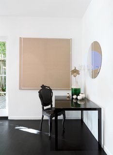 A Traditional Home and an Impeccable Eye - Photo 6 of 8 - In the dining room, a Smoke chair by Marten Baas for Moooi keeps company with a glass-and-ceramic vase by Hella Jongerius and a mirrored steel painting by artist Michelangelo Pistoletto.