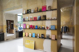A Design Boutique Opens in Poland - Photo 1 of 7 - Books are displayed on one wall in a room of the Geszeft boutique that houses a cafe. Photo by Anna Domańska.