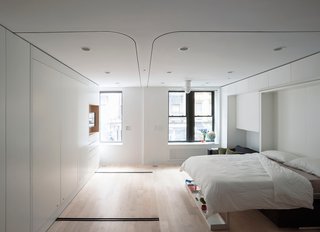 Modern Murphy beds cleverly marry form and function. This Murphy bed with couch also features a shelf at the foot of the bed that doubles as decor and handy storage. Here's the bed transitioned from day mode to sleep mode.