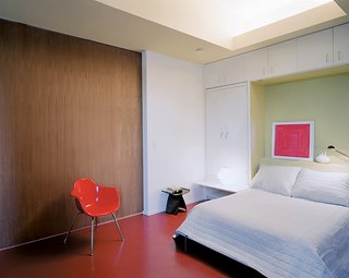 A folding bed and pullout bedside tables make the transition from photography studio to bedroom painless.