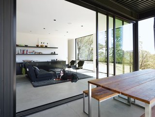 Located just off the kitchen, this room was originally designed for dining—the adjustable Ligne Roset Crescendo coffee table can be raised to 28.75 inches—but most days Bill and Abbie prefer to eat outside or at their casual Caesarstone-topped kitchen island. Today the space serves as a sunny reading spot and guest room, with a convertible futon (from Ligne Roset, since discontinued) and a set of leather-and-steel Paulistano armchairs from Design Within Reach.