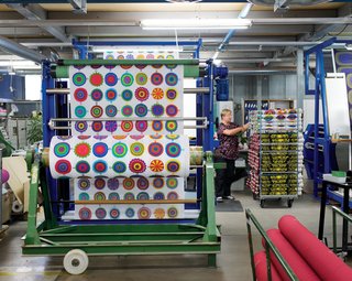 Designers Maija Louekari's Lappuliisa fabric is cut and rolled into bolts. Follow us as we step inside Marimekko’s printing factory for a look at how its iconic textiles come to life.