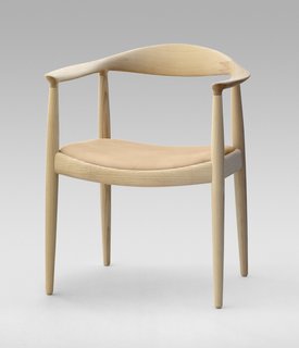 8 Iconic Chairs by Hans Wegner - Photo 2 of 9 - The Round Chair from 1949 is one of Wegner's most iconic pieces and a highlight of Danish design. "Round One" is minimalist art reduced to its bare essentials. It required incredible craftsmanship to create such smooth curves—each of the crescent-shaped armrests are fashioned from a block of wood, and interior mortise-and-tenons hide the connection between the arms and legs. Famously, when Kennedy and Nixon sweated it out during the first televised Presidential debate, they were both sitting on Wegner’s design. Manufactured by PP Møbler. Photo by Jens Mourits Sørensen.