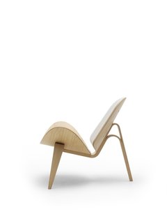 8 Iconic Chairs by Hans Wegner - Photo 6 of 9 - The public was initially reluctant to accept the Three-Legged Shell Chair (1963), an edgier piece of work, from Wegner, which debuted at the 1963 Furniture Guild Exhibition in Copenhagen, but has become more attracted to the wavy, airy design since the chair was reintroduced in 1998. Photo courtesy of Carl Hansen & Son.