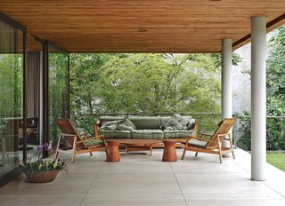 Blockbuster Movies Can't Compete with These Monumental Views - Photo 4 of 9 - The travertine terrace just beyond the living room has a pair of chairs, coffee table, and sofa by local furniture maker Saccaro.