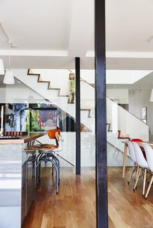 When Molly Alexander and Graeme Anthony were looking for a house to renovate for their growing family—including five-year-old Chloe, seen here—they didn’t expect to find it right next door to Alexander’s own childhood home. The light-filled sanctuary they created features vintage Singer sewing stools at the American walnut–topped kitchen island and hanging lamps from Ikea.