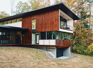 Floors are sealed and waxed concrete. The 4,200-square-foot home is clad in stained local tongue-in-groove cypress.