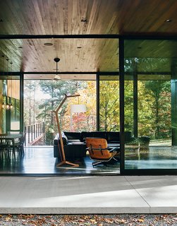 In the living room are a sectional by American Leather for Room & Board, an Eames lounge chair and ottoman, and a custom floor lamp and coffee table by Jeremy Clark and Ed Haynes.