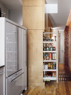 Storage-Smart Renovation in New York City - Photo 13 of 14 - The sliding pantry cabinet doubles as a room divider when fully extended, separating the kitchen from the bedrooms.