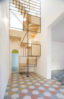 Francesco Librizzi's oak-and-steel staircase is as much a sculpture as it is a means of going between floors. The architect built the staircase for the Casa G project as a means to slow the ascent, to create stations that infused the interior with life.