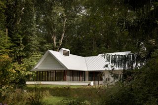 After: "When you’re doing a second home, a lot of the character of the design is defined by what it isn’t," Howe adds, as a way of explaining the minimalistic approach that was taken on this Michigan weekend home. "If you think of it as cold, you have to remember that the setting and access to nature is the point."
