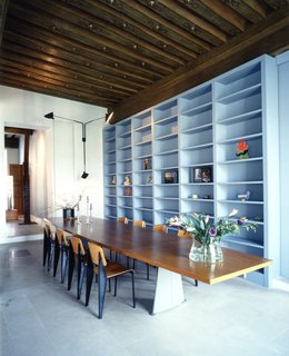 7 Modern Architects at Home - Photo 1 of 9 - Francesca Molteni writes, "A table, a window, a royal square, statues and horses. In Paris, Place des Vosges, Doriana and Massimiliano Fuksas’s home. Original Jean Prouvé furniture, and masses of artworks, from Fontana to Paladino. On the threshold, antique warriors stand guard over the house and protect it, like custodians awaiting the return of its traveling architects."
