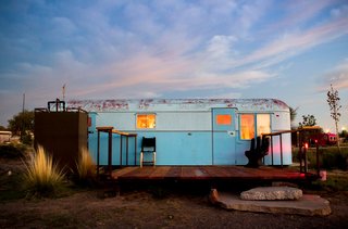 A sky-blue vintage trailer blends in with the sky.