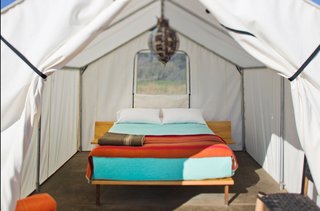 Brightly colored sheets and a central pendant lamp show this tent to its best advantage.