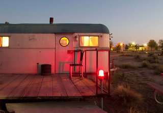 With the residents awake inside, this trailer's burnished glow reflects the sunset.