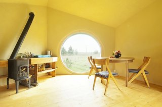 The interior of Jaanus Orgusaar's NOA cabin in the Virumaa region of Estonia. The unique shape of the dwelling creates a very open interior.