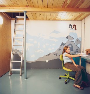A Minneapolis Building That Has Lived Multiple Lives Is Revitalized by a Coffeehouse Owner - Photo 9 of 10 - Eve works at the desk in her double-height bedroom. Vogt’s mythically aquatic-themed mural reflects both the taste of a young girl and the pared-back aesthetic of any modern enthusiast.