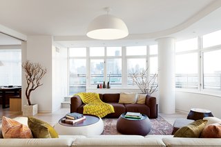 Though two sofas enclose this living area, neither sofa is against a wall. This allows the rounded exterior wall to be sectioned off as its own space.