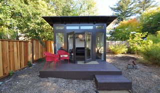 A raised deck with bold chairs and simple welcome mat finish this work retreat. 