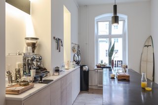 Freunde von Freunden and Vitra’s Berlin Apartment - Photo 5 of 9 - Kitchen of the Freunde von Freunden X Vitra ApartmentRide the wave: The sleek, open kitchen, centered around the custom black marble island with none-too-subtle Southern California callouts like the surfboard in the corner, is Frede’s favorite room. The kitchen fixtures and countertops are by Miele and Dornbract. Photo by Steve Herud