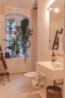Freunde von Freunden and Vitra’s Berlin Apartment - Photo 8 of 9 - Bathroom of the Freunde von Freunden X Vitra ApartmentHanging plants and an open shower accentuate the bathroom’s light, airy layout. Sink by Alape, shower and fixtures by Dallmer and Dornbracht.Photo by Steve Herud