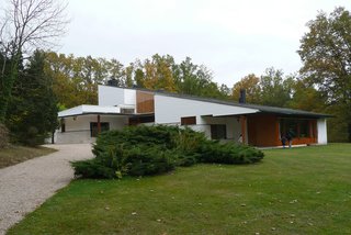 Maison Louis Carre (Bazoches-sur-Guyonnes, France :1959)<br><br>Created for an acclaimed art dealer, this sloped home rises out of the hills, itself clad in the same sandstone used for a nearby cathedral. Curved wooden walls and a large window make for a light-filled interior, and the grand entrance boasts a large display wall for artwork.<br><br>(Credit: workflo, creative commons)