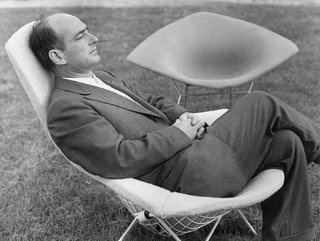 Bertoia, here shown sitting in one of his famous chairs, designed in 1951 for Knoll.