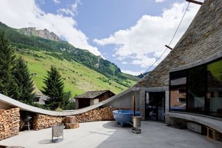 Villa Vals is subtly out carved from an alpine slope in Vals, Switzerland. The unique design by SeARCH and Christian Müller Architects provides both a comfortably sized patio and stunning mountain views while remaining visually unobtrusive in the pastoral landscape. 