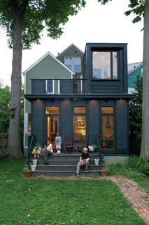 Juliet Gray, Mathias Kolehmainen, and their sons Cooper and Cyrus have a new favorite hangout: the wide back steps on the addition, which double as theater seating. (They project movies from the second-floor balcony onto an out-building across the yard.)