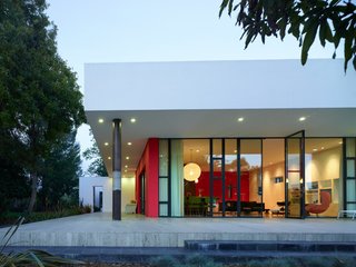 Windows shielded by the white overhand of the roof offer an elegant facade while shielding residents from the glare of the sun's sharpest rays.