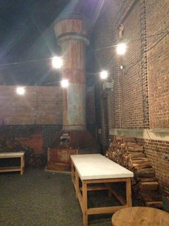 The original smokestack from the roof of the showroom was retrofit to house a wood-fired pizza oven. Rumor has it that this smokestack oven can cook 10 pizzas in 90 seconds.