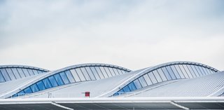 The waves in troof draw natural light into the new terminal while helping to define three distinct phases of each passenger's airport experience: check-in, security, and departure. Photo courtesy of Luis Vidal + Architects.