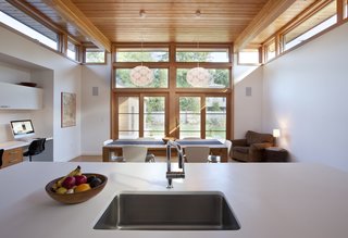 12 Striking Examples of Clerestory Windows in Modern Homes - Photo 12 of 12 - The owners requested that the kitchen act as the center of the home so it was built at the rear of the property. "It allowed us to pop off the roof and add clerestory windows to bring in an abundance of sunlight and fresh air," DiRocco said. The sink is by Blanco and the faucet is by Grohe.
