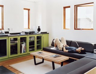 Andy Hong tunes out with his hi-fi system in the living area of his ground floor. The big room contains a kitchen, a washer-dryer, and ample work surfaces. "Since I travel a lot," he says, "I really look forward to hanging out in the big room, catching up with my hobbies and doing laundry."