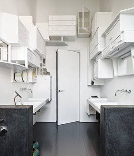 Wenes asked artists from Studio Simple to devise an imaginative storage solution for the bathroom. Starting at one end of the room and working their way across, the team assembled chests and cabinets found at a thrift shop and painted them all white. "It’s like a mosaic," says Wenes. "It’s a very personalized concept—I feel like it’s my bathroom."