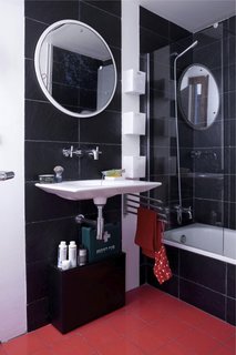 In the bathroom, recycled plastic tiles surround the tub. Designed by Ramón Benedito for Roca, the Kalahari sink was fashioned from a single piece of ceramic. "There’s less waste than the standard sink," says Scholtus, who also installed low-flow aerators in the faucets and a Stop Flush water-conserving toilet.<br><br>Don't miss a word of Dwell! Download our FREE app from iTunes, friend us on Facebook, or follow us on Twitter!