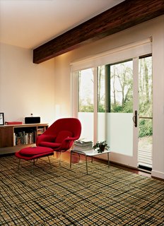 An Eero Saarinen Womb chair sits in the master bedroom, which also has a small office space.
