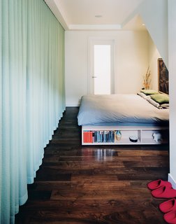 A curtain wall obscures the closet in the master bedroom.