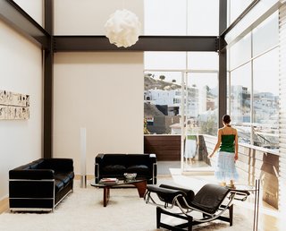 The table's distinctive curved wood base and glass top reveal a harmony that's characteristic of Noguchi's work.