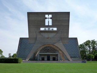 Design Icon: 10 Buildings by Marcel Breuer - Photo 6 of 11 - In 1950, Abbot Baldwin Dworschak solicited forward-thinking designs from leading architects to remake his Minnesota church and create a monument to the service of God. Breuer answered the call. There's a certain majesty to the bell tower greeting the faithful, a massive panel supported by a curvaceous stand. That Breuer then follows it up with the church itself, with a massive wall of hexagonal stained glass and concrete tresses, makes this a classic.