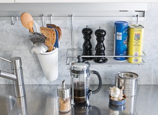 The Abbinks’ apartment is a study in details, from the stainless steel kitchen countertop to the clever Arclinea rail system that holds their salt and pepper.