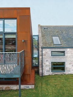 15 Modern Additions to Traditional Homes - Photo 13 of 15 - Cor-Ten steel from a ship building yard clads the new structure, which connects via a glass "bridge" to a rebuilt stone farmhouse containing the bedrooms.