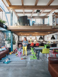 The bottom floor contains the kitchen and the dining area; the lounge is upstairs. The cabinets are from Ikea, as are the table and chairs, and the child’s Tripp Trapp chair is from Stokke.