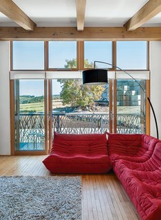 The lounge, with maple flooring from an old school in nearby Aberdeen, has a Togo sofa by Michel Ducaroy for Ligne Roset.