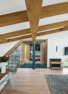 Reclaimed oak beams dominate the upstairs lounge, which leads to the guest bedroom.