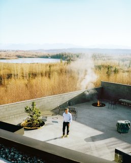 This Modern Cabin Is the Ideal HQ For a Family in Alaska - Photo 6 of 19 - The courtyard with its fire pit and infinity pond—extends the living area outdoors. The family has hosted events, weddings, and even a funeral here, and annual solstice parties are always a big hit with the neighbors.
